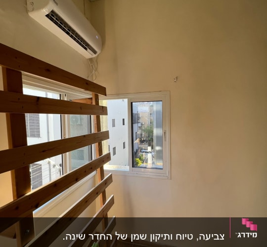 קיר צבוע בצבע בהיר ליד חלון קטן